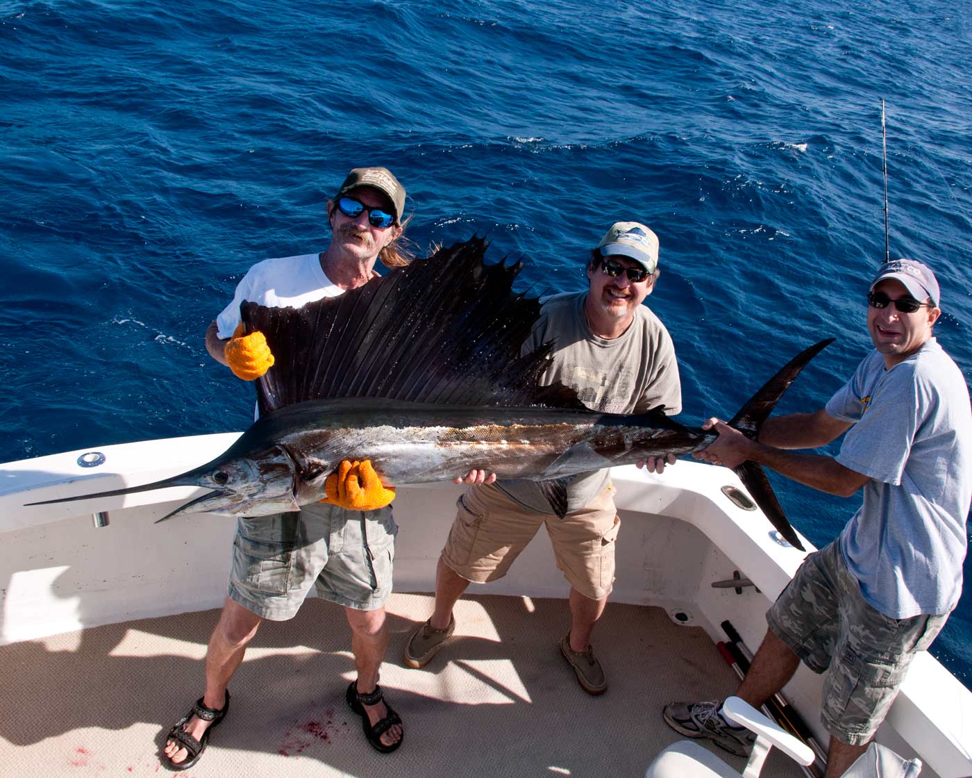 Lon helps Kevin hold his sailfish for pictures